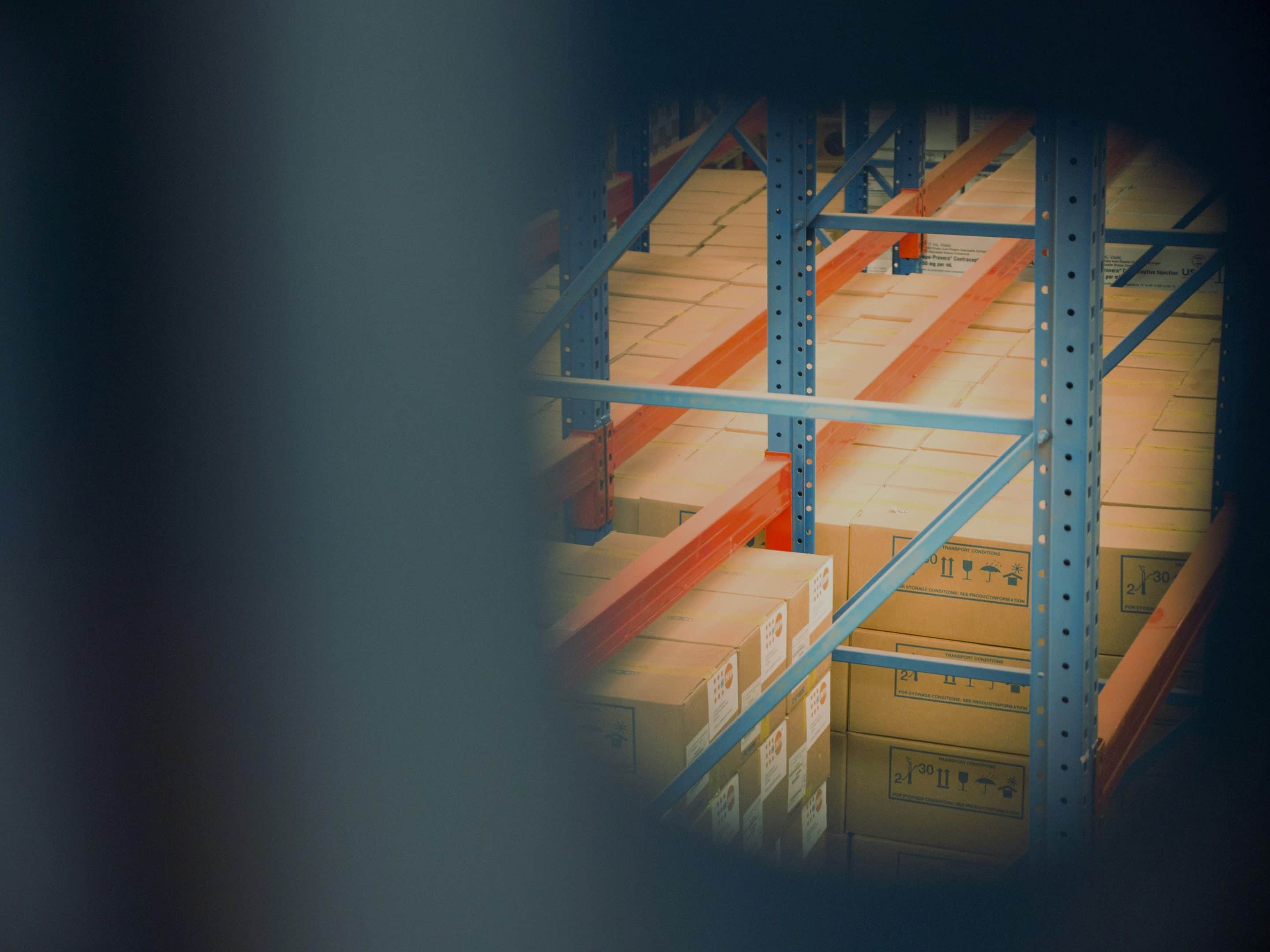 Warehouse storage with stacked cardboard boxes.